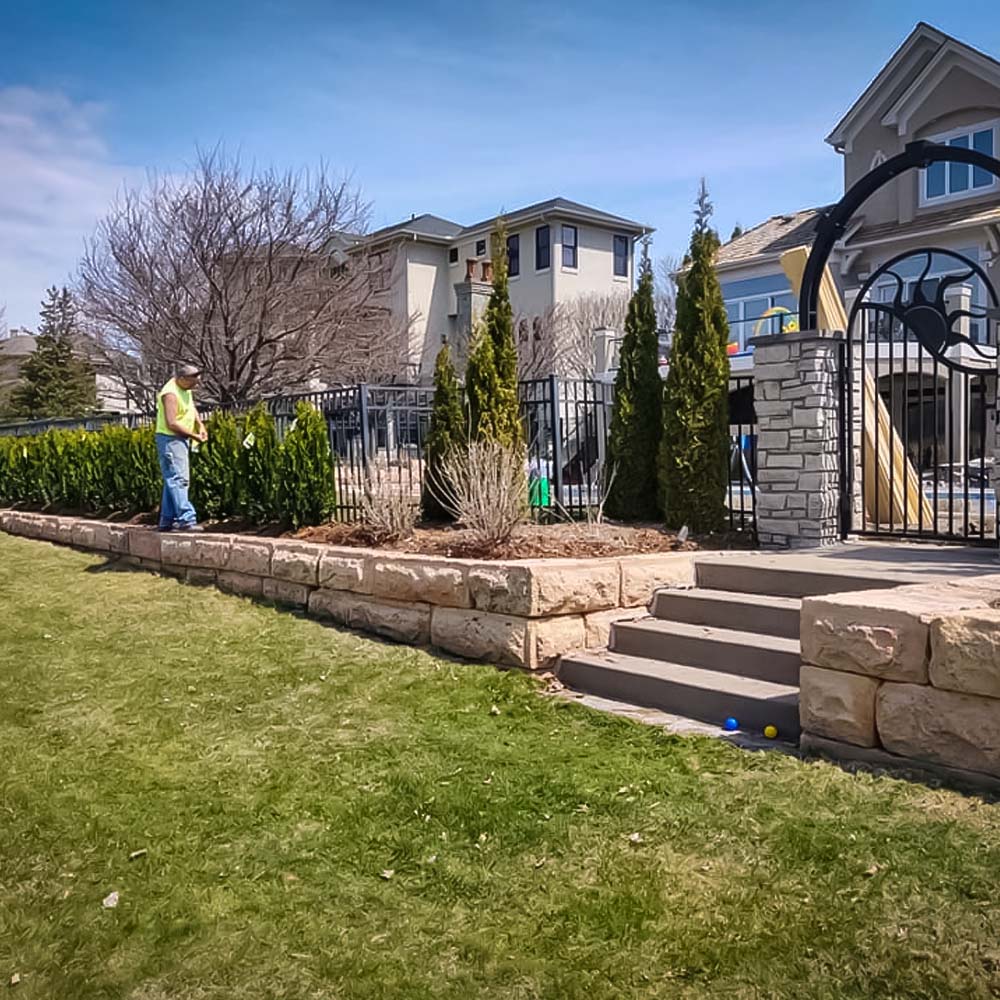 Stone paver patio bordered by fresh plantings